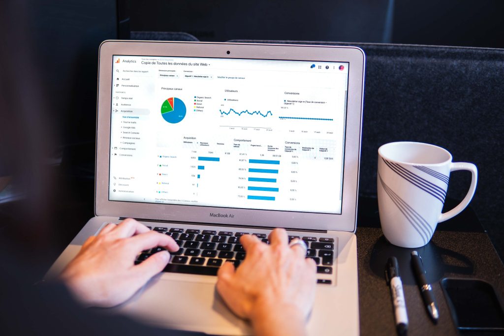 myriam-jessier-eveI7MOcSmw-unsplash A laptop screen showing metrics, graphs, and charts